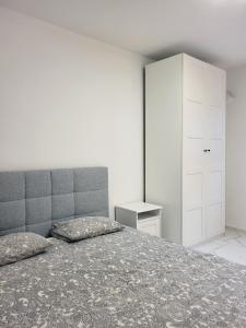1 dormitorio con 1 cama y armario blanco en Stara Pošta Apartment 1, en Grosuplje