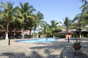 a resort swimming pool with palm trees in the background at Bojo Beach Resort in Botianaw