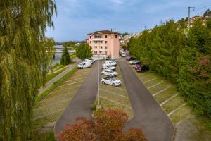 Une rangée de voitures garées sur un parking dans l'établissement Hotel an der Reuss, à Gisikon