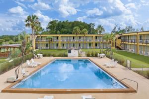 an exterior view of a resort with a large swimming pool at Days Inn by Wyndham Lake City I-75 in Lake City