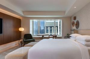 a hotel room with a large white bed and a window at Park Hyatt Chicago in Chicago