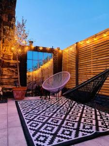 a patio with a hammock and a table on a patio at Chapter Two - Melbourne in Melbourne