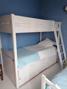a white bunk bed with a ladder next to a wall at Gîte des peupliers, gîte à la ferme 