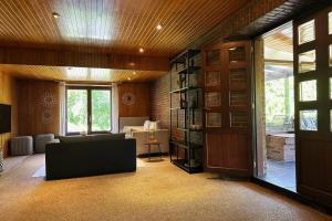 een woonkamer met een bank en een boekenplank bij Vakantiewoning Hoogveld in Kortessem