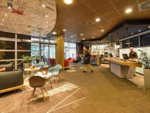 a lobby of a store with tables and chairs at Ibis Budapest City in Budapest