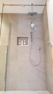 a bathroom with a shower with a glass door at St Annes Beach Apartments in Lytham St Annes +63 photos
