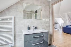 a bathroom with a sink and a mirror at Le Bâle in Strasbourg