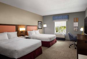 a hotel room with two beds and a window at Hampton Inn & Suites State College at Williamsburg Square in State College +20 photos