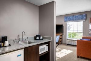 a kitchen with a sink and a window in a room at Hampton Inn & Suites State College at Williamsburg Square in State College