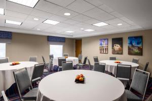a conference room with white tables and chairs at Hampton Inn & Suites State College at Williamsburg Square in State College