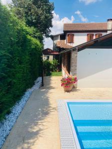 a villa with a swimming pool next to a house at Corte Bussari in Arquà Polesine