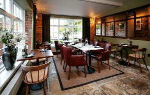 a restaurant with tables and chairs and a window at New Holgate in York