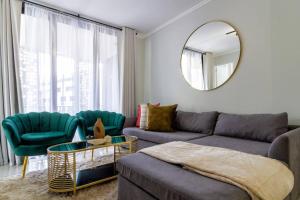 a living room with a couch and a mirror at #AlimamaSpaces: Jay's Cassini in Midrand +40 photos