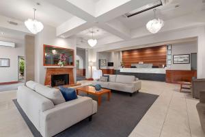 a living room with two couches and a fireplace at Quality Hotel Mildura Grand in Mildura