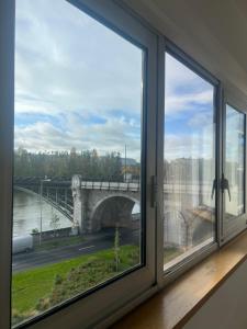 a window in a room with a view of a bridge at Courbevoie Riverview in Courbevoie