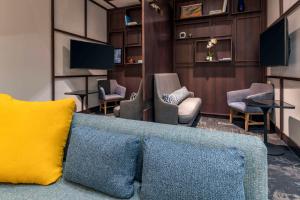 a living room with a blue couch and chairs at Hyatt Place Provo in Provo