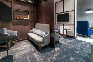 a waiting room with a chair and a tv at Hyatt Place Provo in Provo