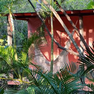a red building with a painting on the side of it at Solea Villa Tropical in Santa Marta