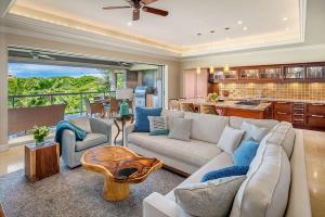 a living room with a couch and a kitchen at Ho Olei Residences - CoralTree Residence Collection in Wailea