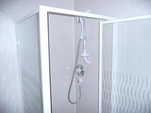 a shower in a bathroom with a glass door at Beijing Dragon Hotel in Spilsby +15 photos