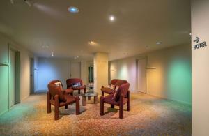 a waiting room with chairs and a table at Canopy by Hilton Cannes in Cannes