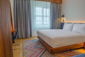 a hotel room with a bed and a window at Hampton By Hilton Sakarya in Sakarya