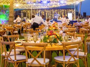 a table set up for a party with people in the background at Mercure Larnaca Beach Resort in Larnaka