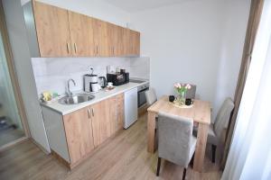 a small kitchen with a sink and a table at Apartman 1 in Kragujevac