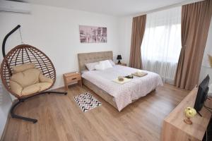 a bedroom with a rattan bed and a chair at Apartman 1 in Kragujevac