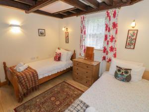 a bedroom with two beds and a window at The Tack Room in Worcester