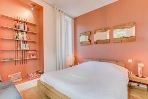 a bedroom with a white bed and a book shelf at Le Campels in Savignac-les-Ormeaux
