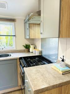 a kitchen with a stove and a counter top at Beach Grove in Scarborough