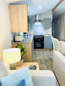 a kitchen and living room with a couch and a table at Beach Grove in Scarborough