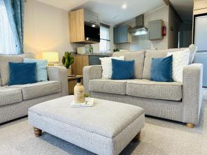 a living room with two couches and a table at Beach Grove in Scarborough