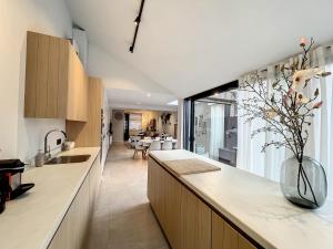 a kitchen with a counter with a vase of flowers at Home @ Bruges in Bruges