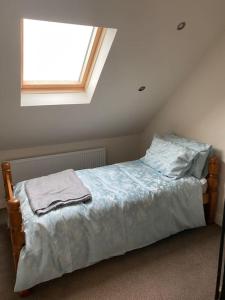 a bed in a room with a window at Breathnach Cottage Annex Knockleagha Ballina F26 D7E2 in Ballina