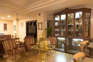 a dining room with a table and chairs at Antika Amman Hotel in Amman