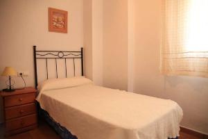 1 dormitorio con 1 cama, vestidor y ventana en Apartamento Cadiz Bajo, en Conil de la Frontera