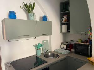 a small kitchen with a sink and a microwave at Cà Rara pied à terre in Marina di Carrara +9 photos