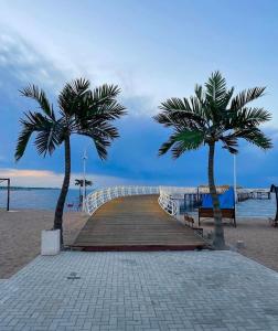 two palm trees on a boardwalk on the beach at Palm_beach in Chok-Tal