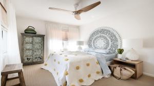 a bedroom with a bed and a ceiling fan at Beachfront at Avoca North in North Avoca
