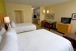 a hotel room with two beds and a television at TownePlace Suites by Marriott Jackson Ridgeland/The Township at Colony Park in Ridgeland