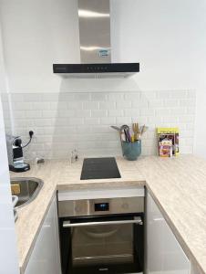 a kitchen with a sink and a stove top oven at Appartement Cosy Aix en Provence in Aix-en-Provence