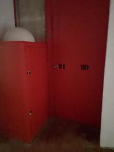 a red door with numbers on it in a room at come and enjoy ! in Cadaqués