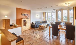 a living room with a couch and a table at Knechtsand - 403 in Cuxhaven