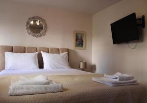 Ένα ή περισσότερα κρεβάτια σε δωμάτιο στο The Ellinikon - Metro Apartment