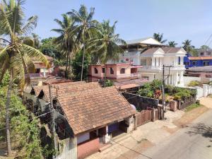 a group of houses with palm trees and a street at The Urban Escape in Udupi