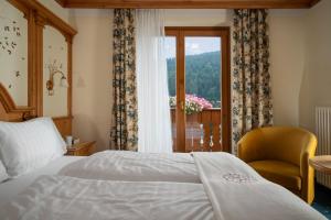 Ένα ή περισσότερα κρεβάτια σε δωμάτιο στο Hotel Gianna