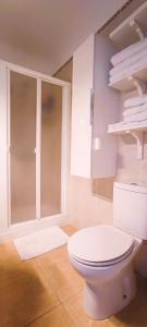a bathroom with a white toilet in a room at Calesapart Tranquilidad con vistas al mar in Candelaria