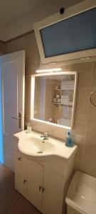 a bathroom with a sink and a mirror and a toilet at Calesapart Tranquilidad con vistas al mar in Candelaria